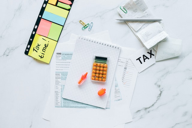 a bunch of tax forms and receipts on a white table