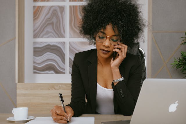 property manager speaking on the phone while taking notes