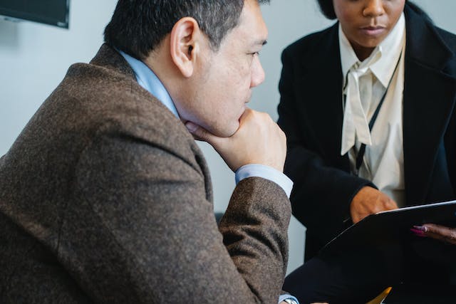 a property manager showing their colleague a document